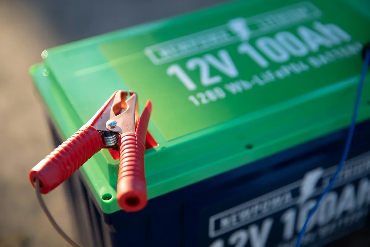 Technician testing a vehicle battery